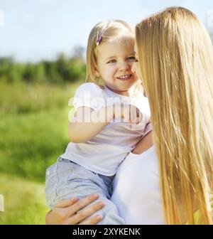 Happy mother and her little daughter in the spring day Stock Photo