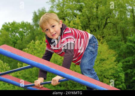 Boy climbing on the playground Stock Photo