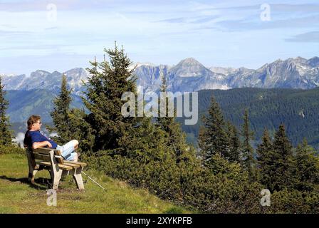 Hiker takes a break in the Dachstein mountains Stock Photo
