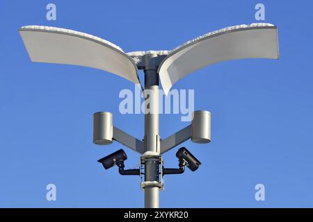 Surveillance cameras and modern lighting fixtures on the lamppost Stock Photo