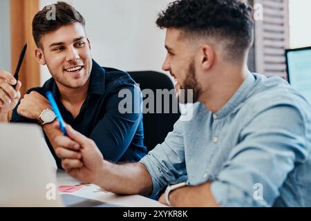 Laugh, team and business men on laptop for brainstorming ideas or discussion at startup office. Collaboration, talking or creative director working on Stock Photo