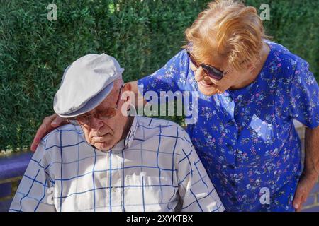 Elderly man napping with his wife in the terrace. Spanish tradition Stock Photo