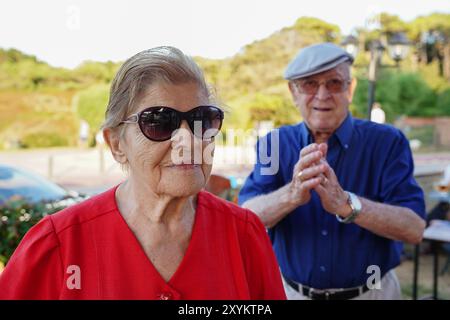 elderly couple having fun and socializing with friends outdoors. Elderly lifestyle Stock Photo