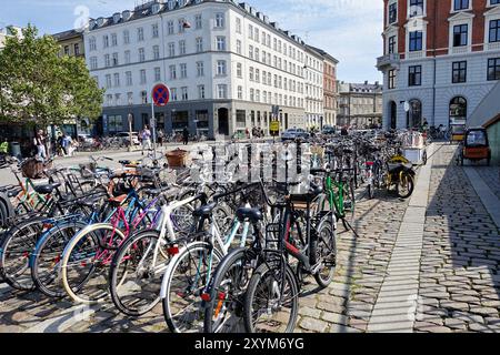 In Copenhagen city centre there is a large, well-used bicycle parking area right next to a bicycle highway Stock Photo