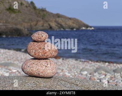 Stone tower in front of coastal landscape on Trysunda Stock Photo