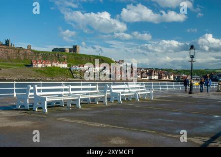 A view from Whitby's west pier with St. Mary's church and Whitby Abbey in the background. Stock Photo