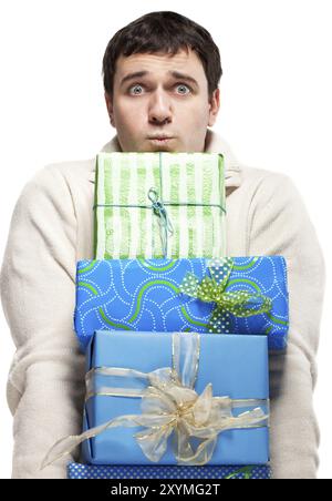 Surprised young man with presents. Isolated on white Stock Photo