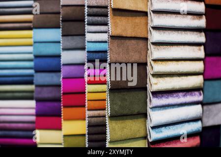 Many different colorful and bright fabric samples for upholstered furniture. Interior design concept. Close-up of a palette of textile abstract diagon Stock Photo