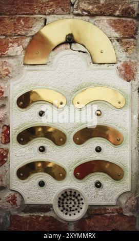 An intercom doorbell panel on the brick wall Stock Photo