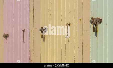 Coloured doors and locks of beach huts on the beach of Budleigh Salterton, Jurassic Coast, Devon, UK Stock Photo