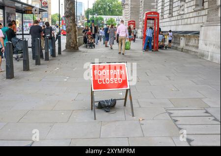 London, UK. Footpath Closed sign on a footpath that doesn't seem to be closed. Whitehall, Westminster Stock Photo