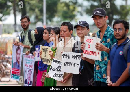 People hold pictures of family members who went missing, during an event organized to mark International Day of the Victims of Enforced Disappearances Stock Photo