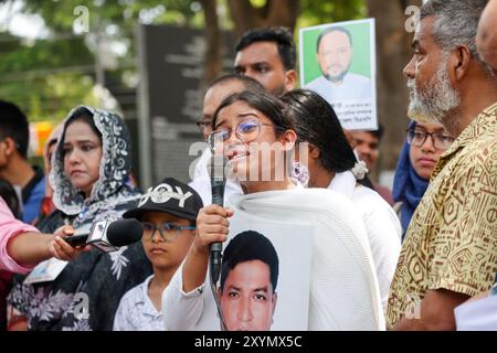 People hold pictures of family members who went missing, during an event organized to mark International Day of the Victims of Enforced Disappearances Stock Photo