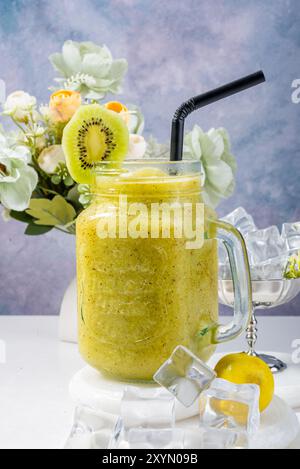 Refreshing Kiwi Smoothie with Floral Decor Stock Photo