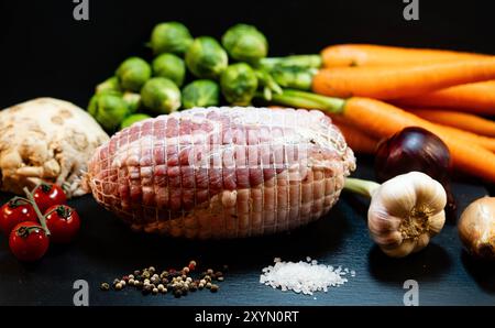 Turkey roll roast with carrots, Brussels sprouts, vegetables and various spices Stock Photo