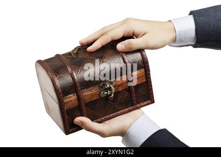 Business man hand holding old antique brown wood treasure chest or box white isolated Stock Photo
