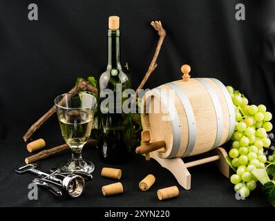 Grapes, wine barrel, wine glass, wine bottle and bottle opener Stock Photo