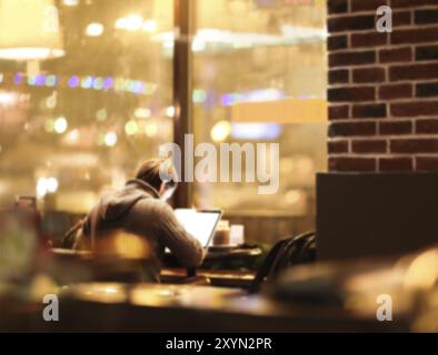 Blurred man with laptop at cafe background, business, technology concept Stock Photo