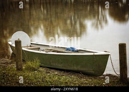 Lonely rowing boat on Lake Chiemsee in autumn Stock Photo