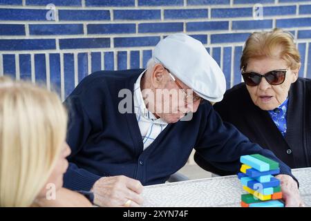 An elderly couple playing board games outside. Leisure in the old age Stock Photo