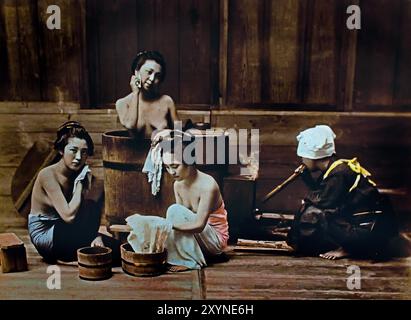 Women Bathing 1890 by Kusakabe Kimbei.  Japanese hand-coloured black and white photo Japan late 19th - beginning of 20th-century vintage albumen photograph ( Historic History ) digital improved reproduction . Stock Photo