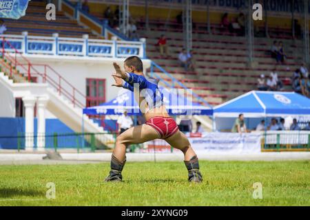 Ulaanbaatar, Mongolia, June 11, 2007: Winning wrestler celebrating with traditional eagle dance inside the National Sports Stadium after a Naadam Fest Stock Photo