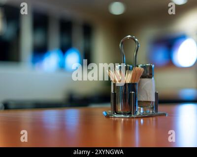 Salt shaker and pepper with toothpicks on the table. Stock Photo