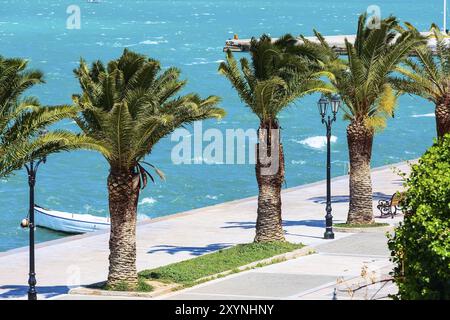 Promenade with palm trees sea in Nafplio or Nafplion, Greece, Peloponnese, Europe Stock Photo