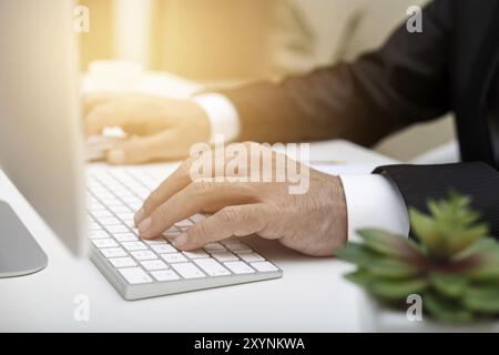 Male hands using modern computer typing on keyboard business concept Stock Photo