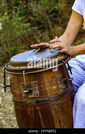 Woman percussionist hands playing a drum called atabaque during brazilian folk music performance Stock Photo