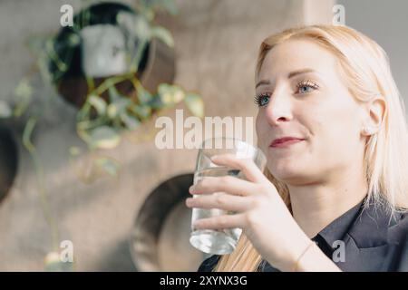 Businesswoman drinking water and taking a break from work Stock Photo