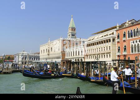 Venice, Italy, August 21, 2012: Doge's Palace, Saint Mark's bell tower and Hotel Danieli view from the lagoon. Tourists are arriving and departing on Stock Photo