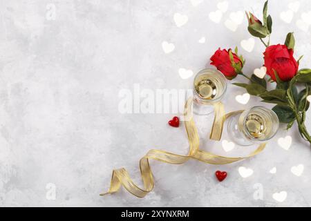 Pair of champagne glasses and red roses, Romantic background. Horizontal Stock Photo