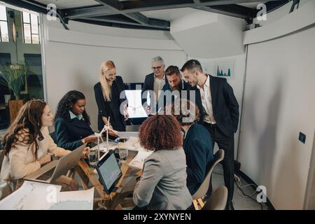 Group of businesspeople is having a meeting in the office, discussing a project about renewable energy Stock Photo