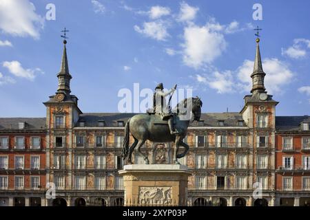 Plaza Mayor in city of Madrid in Spain, painted facade of Casa de la Panaderia and statue of King Philip III from 1616 Stock Photo