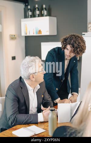 Business people having a discussion while working together during a meeting around a table Stock Photo
