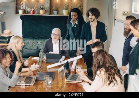 Diverse team of businesspeople are having a productive meeting in a modern office, collaborating and strategizing Stock Photo
