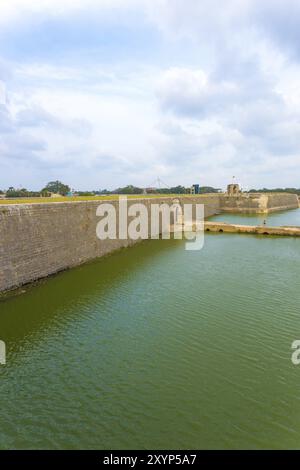 Distant view of entrance and bridge over moat into Jaffna Fort in Sri Lanka. Vertical Stock Photo