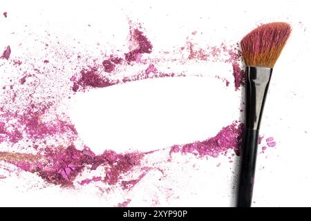 Traces of vibrant pink powder and blush forming a frame, with a makeup brush. A square template for a makeup artist's business card or flyer design, w Stock Photo