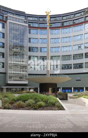 The circular courtyard of Television Centre, London. Former home of BBC Television. Shows Helios statue by T B Huxley-Jones andHe mosaic by John Piper Stock Photo