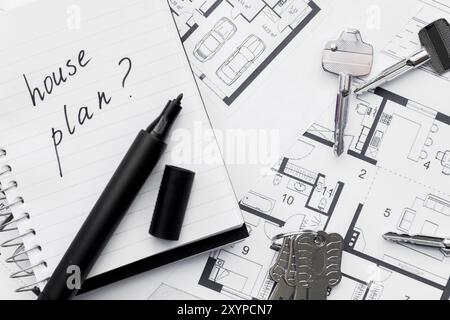 house plan with question mark sign written notebook with felt tip pen keys blue print Stock Photo