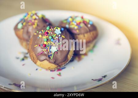 Homemade sweet cupcakes on a plate with colourful decoration Stock Photo