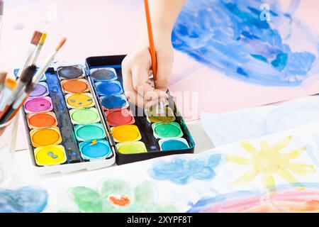 Detail of a child's hand painted with watercolours Stock Photo