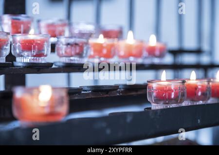 Close up of candles in old catholic church, blurry background Stock Photo