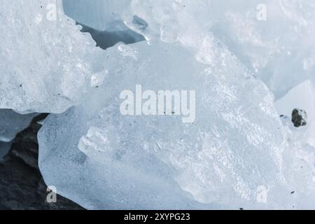 Close-up pieces of ice showered in the ice grotto of a glacier. The destruction of the glacier. Global warming. Small DOF Stock Photo