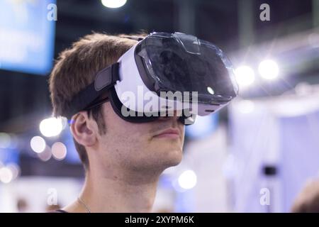 Young man is using virtual reality glasses on an expo Stock Photo