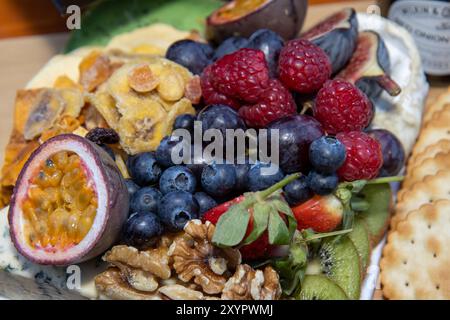 A large selection of fruits and nuts on a platter including blueberries, passion fruit and many more Stock Photo