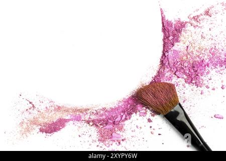 Traces of vibrant pink powder and blush forming a frame, with a makeup brush. A square template for a makeup artist's business card or flyer design, w Stock Photo