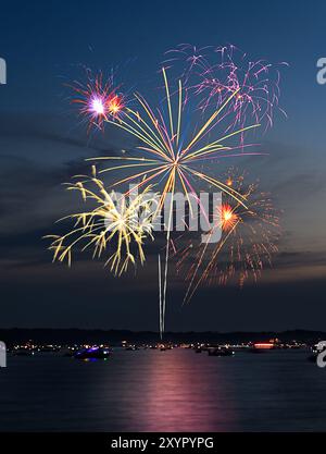 Composite of Fireworks Against Blue-Black with Shoreline and Reflections 14-30 Stock Photo