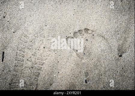 Imprint of two feet in the sand Stock Photo